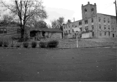View of the church, basketball goal, and playground equipment taken from the pile site