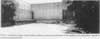 Northwest corner of the northern building, shows good condition of the loading dock and profuse vegetation growing on exposed soils