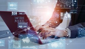 System engineering concept. Engineer working in the office. GUI (Graphical User Interface). Engineer working in the office, typing on a laptop, with overlay of GUI (Graphical User Interface).