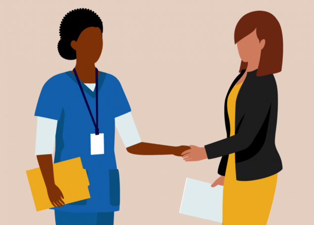 A nurse in a blue smock shaking hands with a woman in a black jacket.