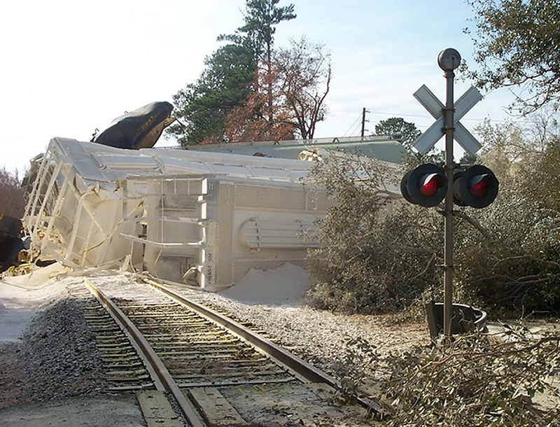 Graniteville Train Wreck Train laying on its side off the train tracks covered in white spray.