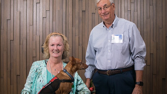 example Caregiver with patient with service dog sitting on wheel chair