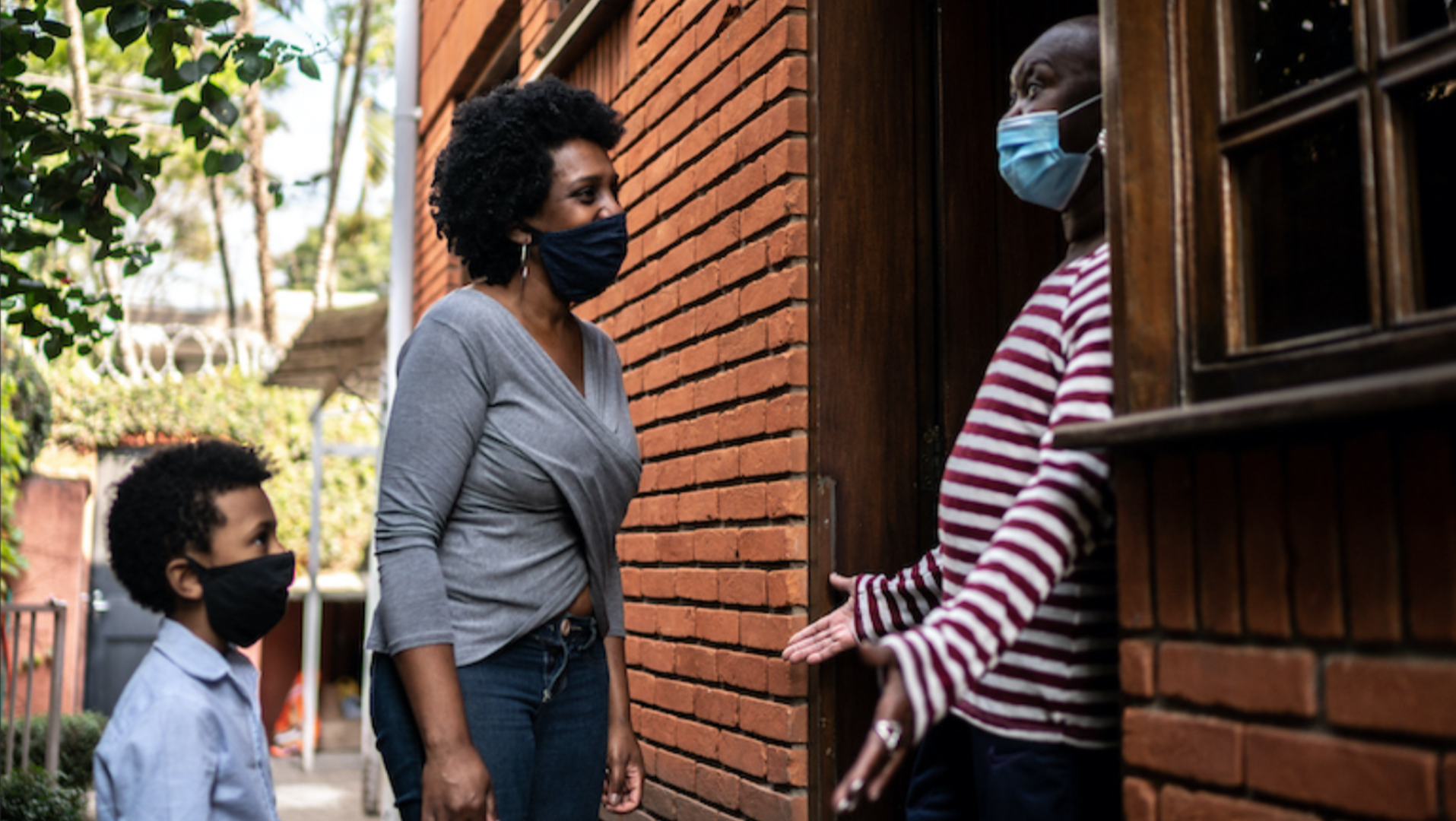 Meeting During COVID Neighbors talking outside with masks on.