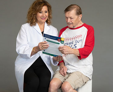 Amyotrophic lateral sclerosis (ALS) patient consulting with his doctor.