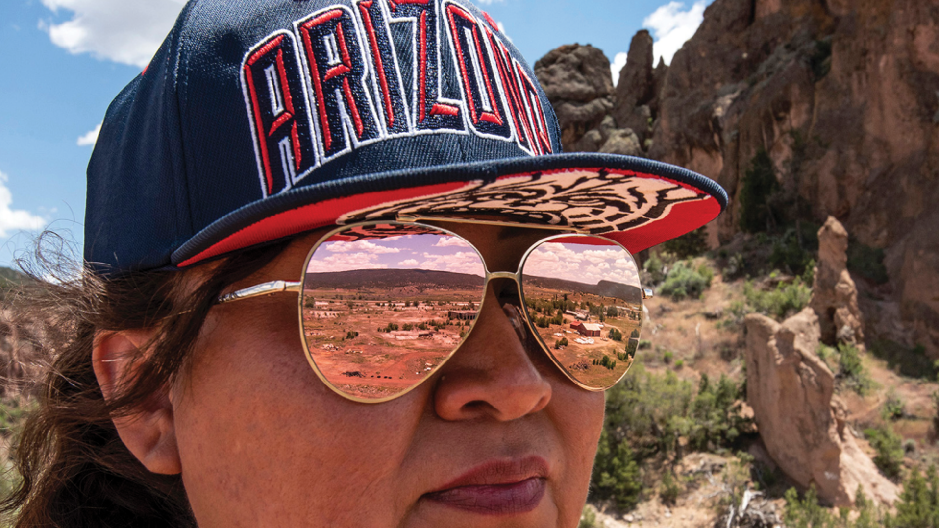 Woman in Arizona Hat Person touring a land reuse site in Navajo Nation (Lloyd DeGrane, 2019)