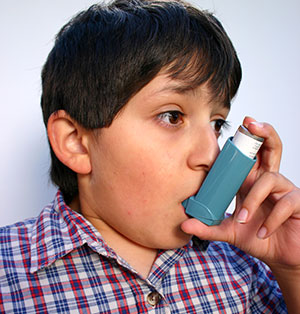 boy using an inhaler boy using an inhaler