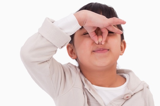 boy holding his nose