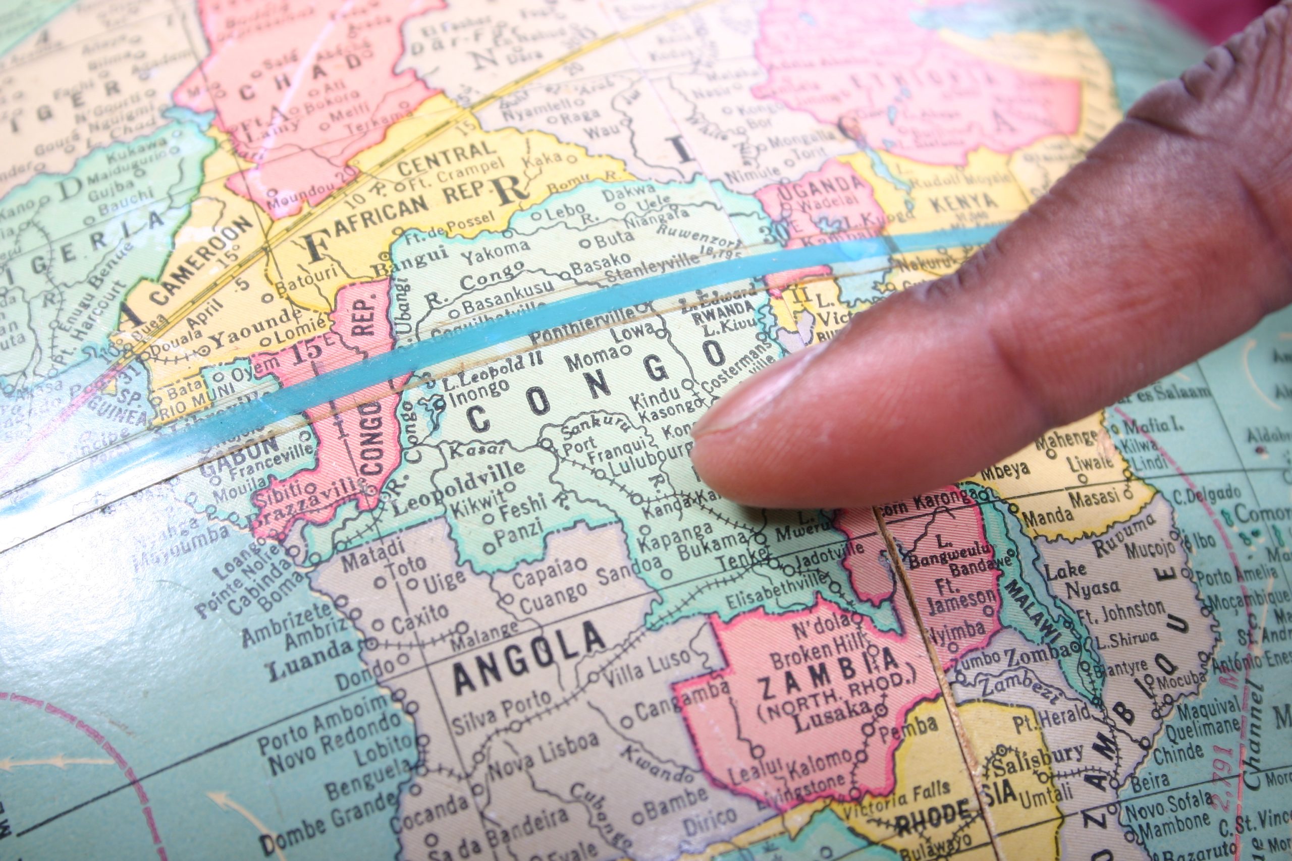 Decorative image of finger pointing to Congo on a globe