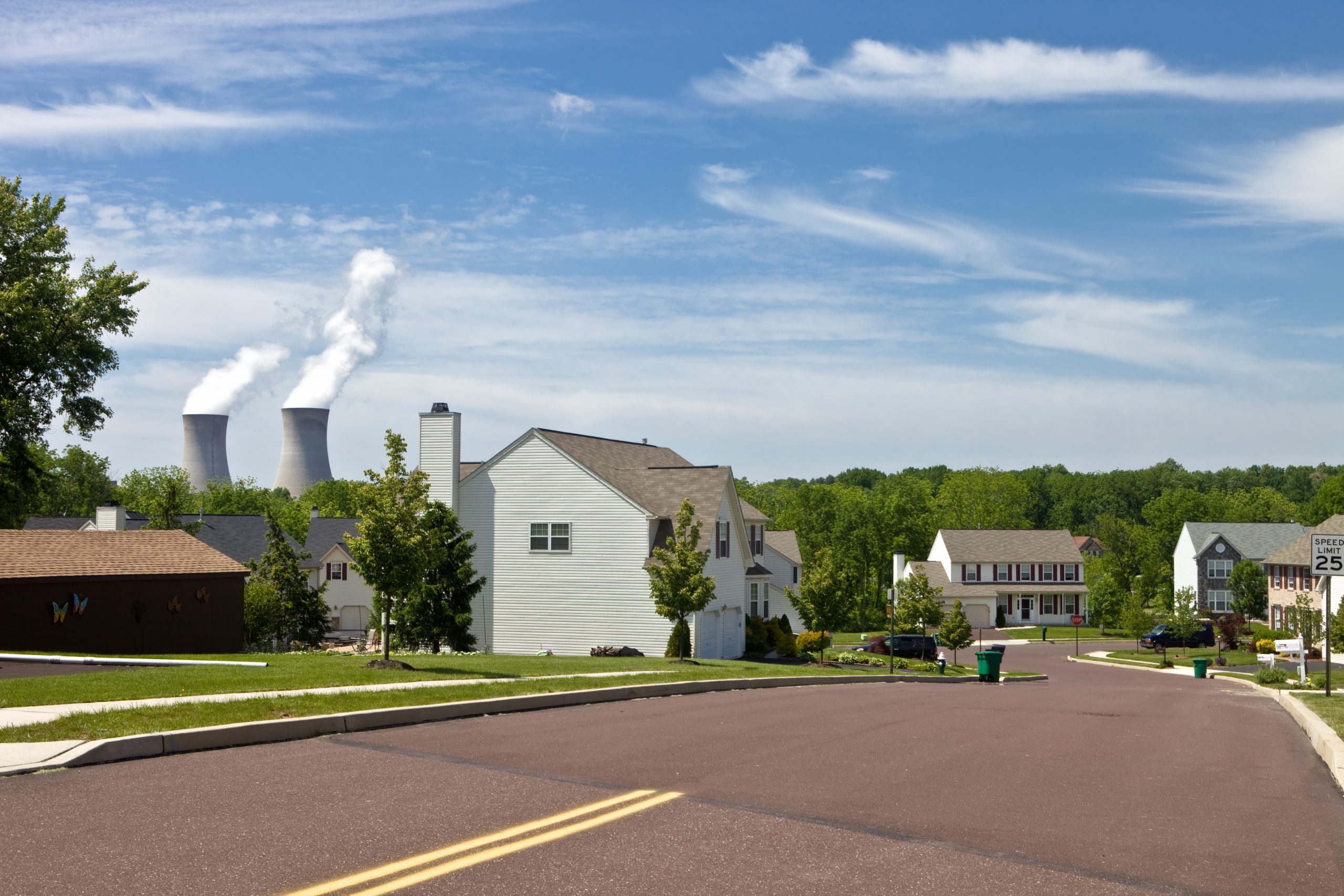 Suburban house with nuclear plant in background