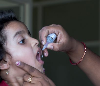 Girl getting drop of polio shot