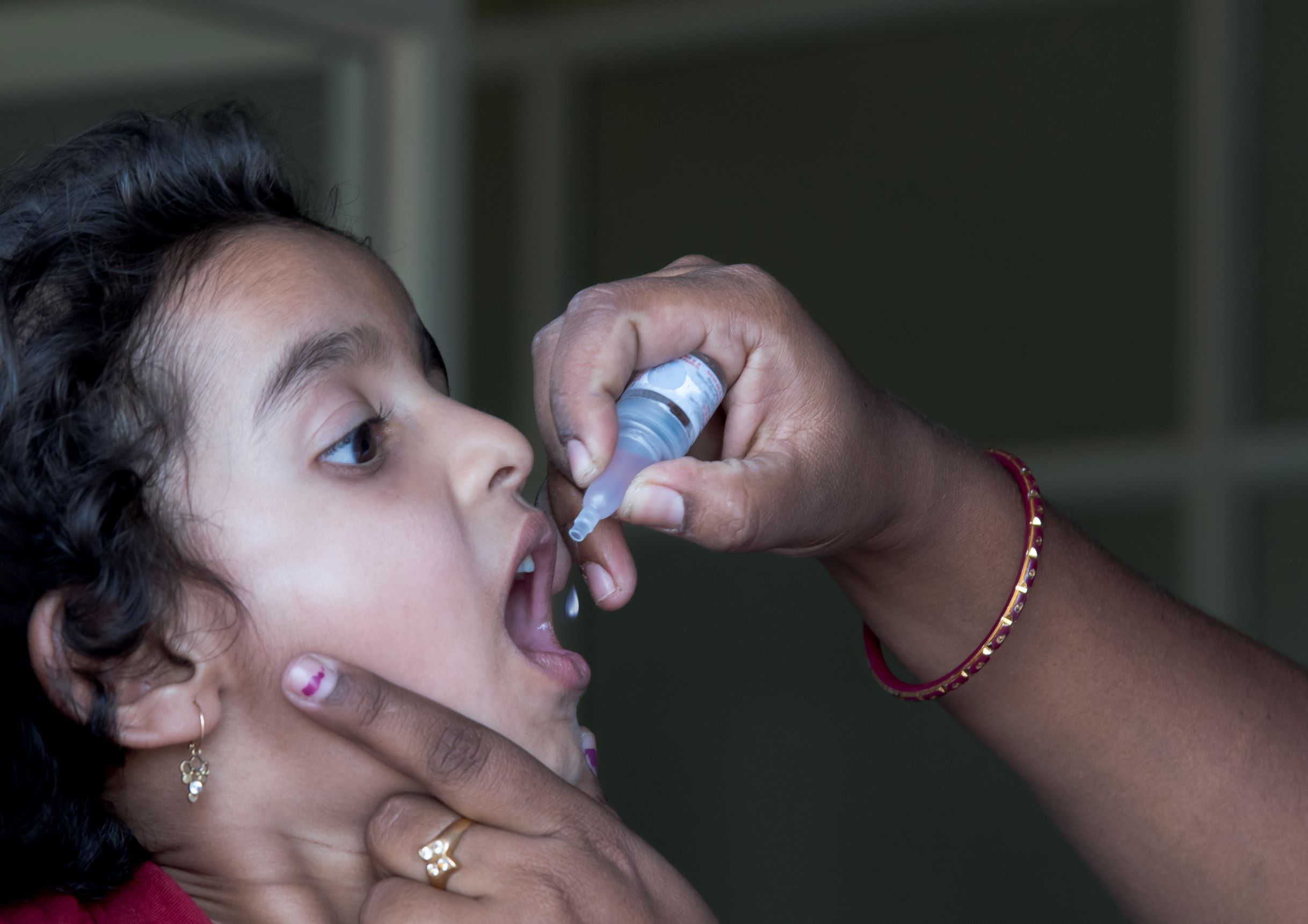 Child receiving polio vaccination in mouth_for web