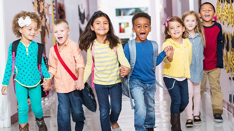 Children playing CSPECE program Multiracial group of preschoolers running down hallway