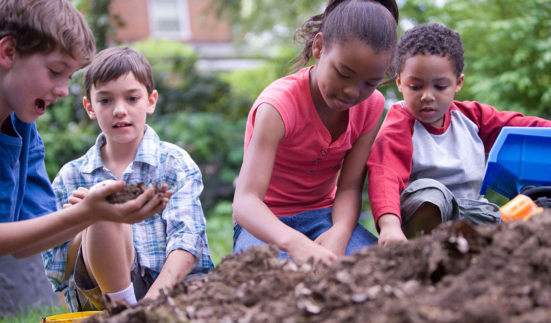 Photo of children playing in the dirt