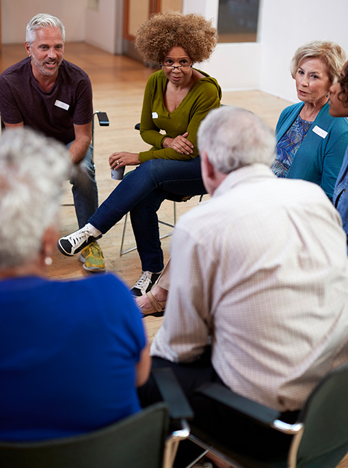 People in a group meeting in a community center.