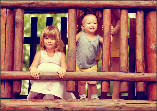 Brother and sister playing on the playground Brother and sister playing on the playground